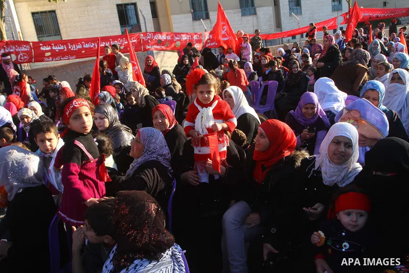 Palestinian supporters of the Popular Front for the Liberation of Palestine (PLFP) wave the group's red flags during a rally held in the northern Gaza Strip town of Beit Lahia on December 10, 2011 to its 44th anniversary...