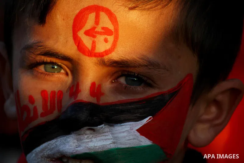 Palestinian supporters of the Popular Front for the Liberation of Palestine (PLFP) wave the group's red flags during a rally held in the northern Gaza Strip town of Beit Lahia on December 10, 2011 to its 44th anniversary...