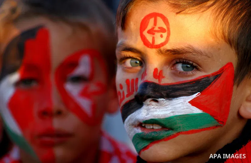Palestinian supporters of the Popular Front for the Liberation of Palestine (PLFP) wave the group's red flags during a rally held in the northern Gaza Strip town of Beit Lahia on December 10, 2011 to its 44th anniversary...