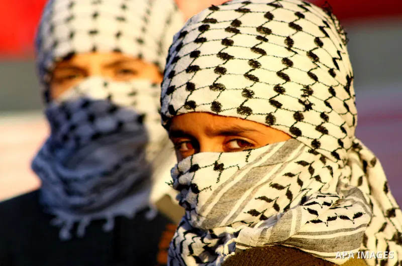 Masked Palestinian boys take part in a rally organized by the Popular Front for the Liberation of Palestine (PFLP) to celebrate the 44th anniversary of its foundation, in northern Gaza Strip December 10, 2011. Photo by A...