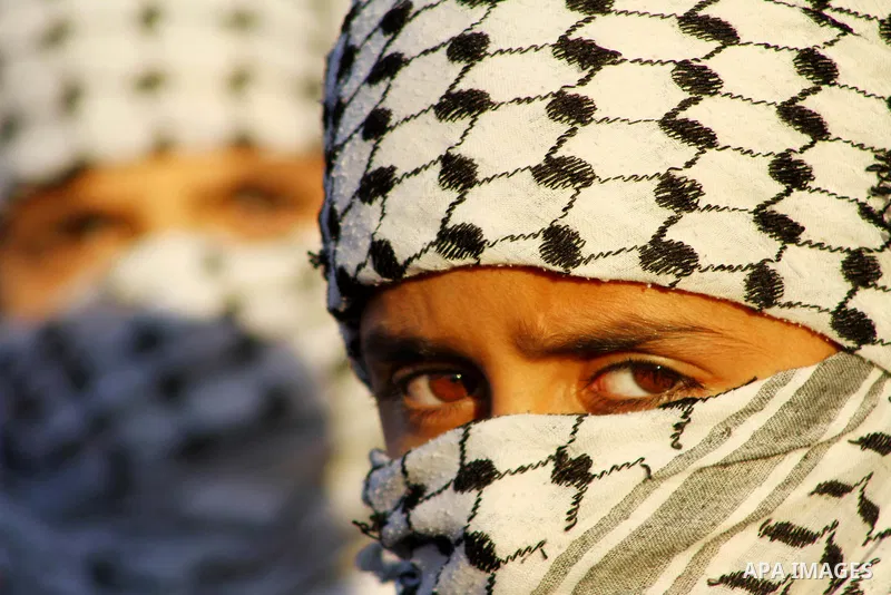 Masked Palestinian boys take part in a rally organized by the Popular Front for the Liberation of Palestine (PFLP) to celebrate the 44th anniversary of its foundation, in northern Gaza Strip December 10, 2011. Photo by A...