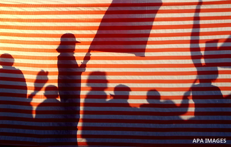Palestinian supporters of the Popular Front for the Liberation of Palestine (PLFP) wave the group's red flags during a rally held in the northern Gaza Strip town of Beit Lahia on December 10, 2011 to its 44th anniversary...
