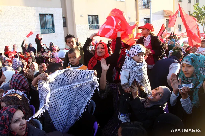 Palestinian supporters of the Popular Front for the Liberation of Palestine (PLFP) wave the group's red flags during a rally held in the northern Gaza Strip town of Beit Lahia on December 10, 2011 to its 44th anniversary...