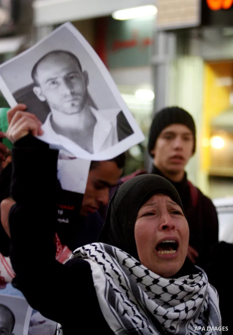 Relatives of Palestinian activist Mustafa Abdelrazek al-Tamimi who died on December 10, 2011 after he was fatally wounded by tear gas the previous day, comfort each other during condolences in the village of Nabi Saleh,...