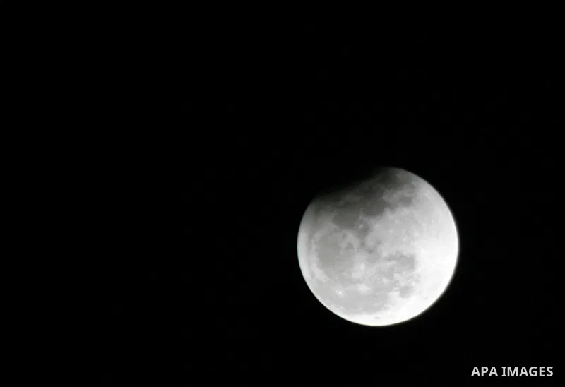 The Earth casts its shadow across the moon's surface during a lunar eclipse in Rafah, in the southern of Gaza Strip on Dec. 10, 2011. This is the second total lunar eclipse of the year and the last until 2014. Photo by A...