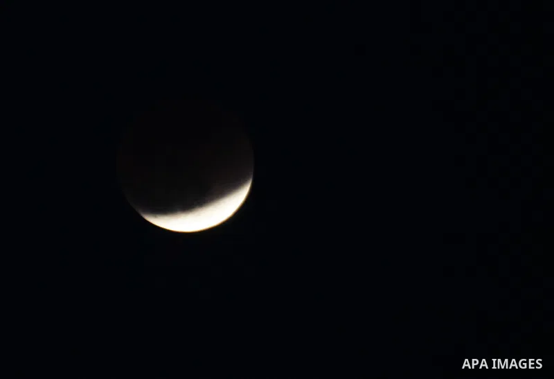 The Earth casts its shadow across the moon's surface during a lunar eclipse in Rafah, in the southern of Gaza Strip on Dec. 10, 2011. This is the second total lunar eclipse of the year and the last until 2014. Photo by A...