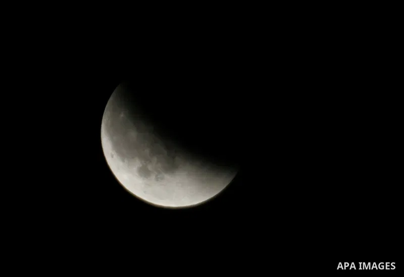 The Earth casts its shadow across the moon's surface during a lunar eclipse in Rafah, in the southern of Gaza Strip on Dec. 10, 2011. This is the second total lunar eclipse of the year and the last until 2014. Photo by A...