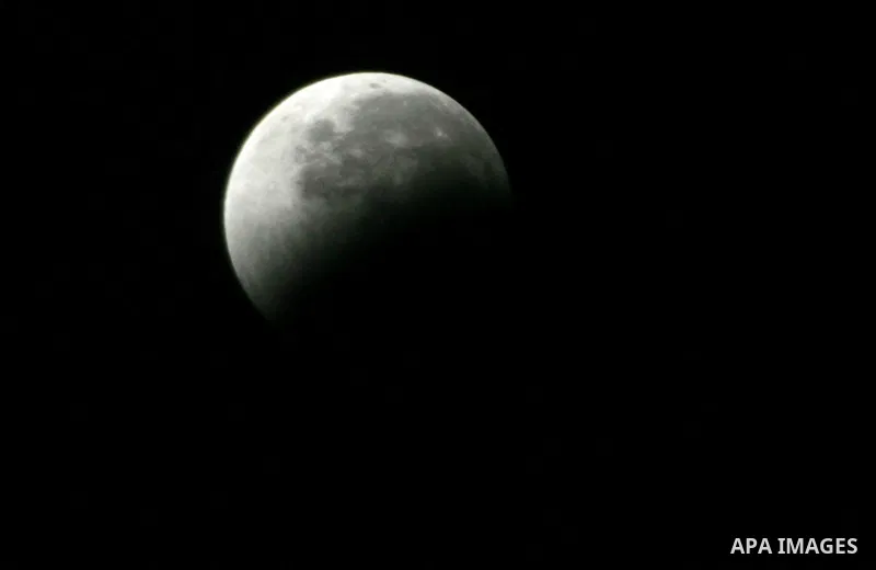 The Earth casts its shadow across the moon's surface during a lunar eclipse in Rafah, in the southern of Gaza Strip on Dec. 10, 2011. This is the second total lunar eclipse of the year and the last until 2014. Photo by A...