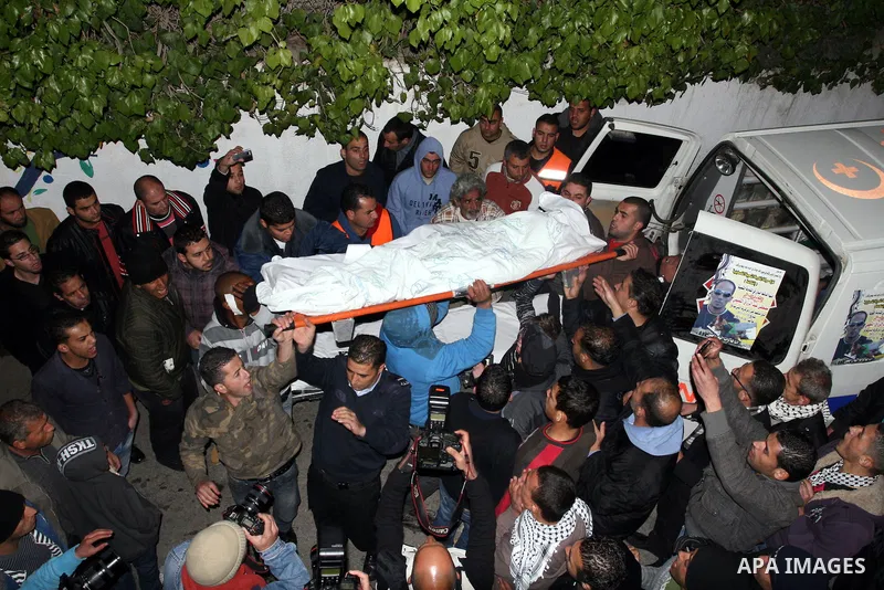 The body of Mustafa Tamimi is seen at the morgue of Ramallah Hospital in the West Bank city of Ramallah, Saturday, Dec. 10, 2011. Tamini, 28, was hurling rocks at an Israeli military vehicle on Friday in the West Bank vi...