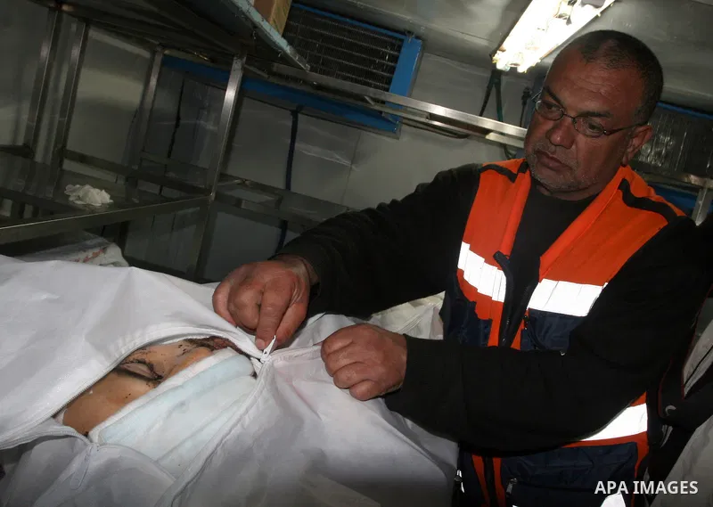 The body of Mustafa Tamimi is seen at the morgue of Ramallah Hospital in the West Bank city of Ramallah, Saturday, Dec. 10, 2011. Tamini, 28, was hurling rocks at an Israeli military vehicle on Friday in the West Bank vi...