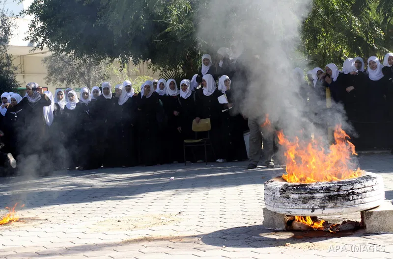 Members of the Palestinian civil defence demonstrate thier skills during a training session following the campaign "your Safety", in school of the girls in Gaza city on Dec. 11, 2011. Photo by Mohammed Asad