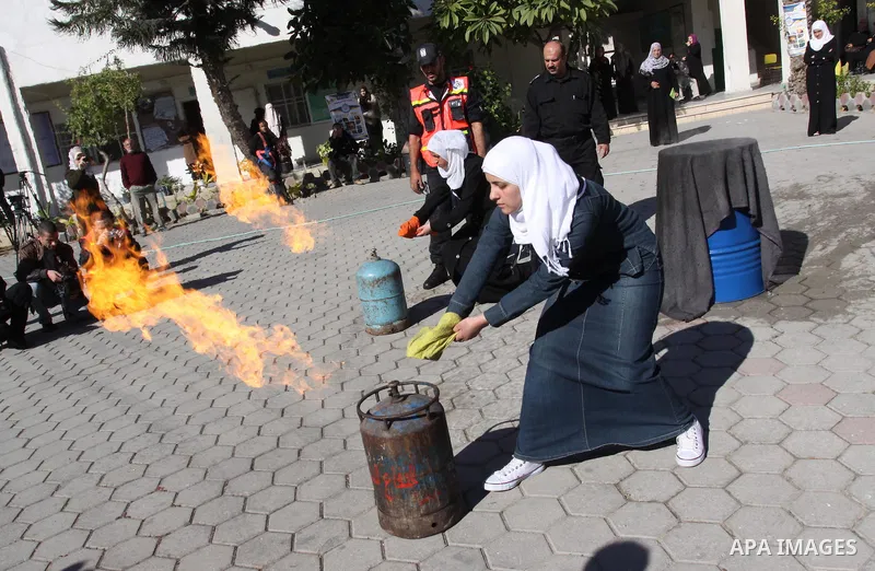 Members of the Palestinian civil defence demonstrate thier skills during a training session following the campaign "your Safety", in school of the girls in Gaza city on Dec. 11, 2011. Photo by Mohammed Asad