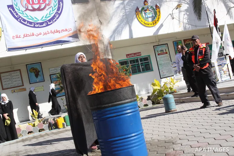 Members of the Palestinian civil defence demonstrate thier skills during a training session following the campaign "your Safety", in school of the girls in Gaza city on Dec. 11, 2011. Photo by Mohammed Asad