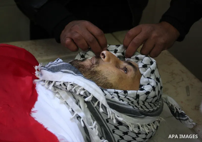 Palestinians prepare the body of Mustafa Tamimi prior to his funeral at a hospital in the West Bank city of Ramallah, Sunday, Dec. 11, 2011. Tamini, 28, was hurling rocks at an Israeli military vehicle on Friday in the W...