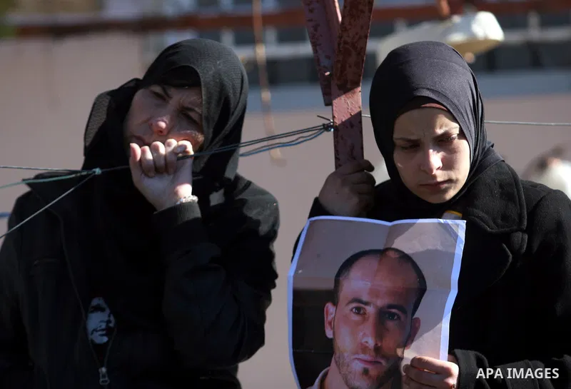 Relatives mourn during the funeral of Palestinian activist Mustafa al-Tamimi in the West Bank village of Nabi Saleh on December 11, 2011. Tamimi, 28, was hurling rocks at an Israeli military vehicle on Friday in the West...