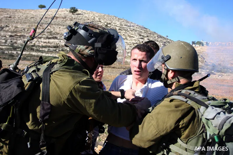 Israeli soldiers detain demonstrators following clashes which erupted after the funeral of Palestinian Mustafa Tamimi in the West Bank town of Nabi Saleh, Sunday, Dec. 11, 2011. Tamimi, 28, was hurling rocks at an Israel...