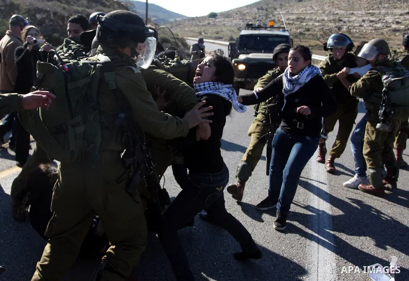 Israeli soldiers detain demonstrators following clashes which erupted after the funeral of Palestinian Mustafa Tamimi in the West Bank town of Nabi Saleh, Sunday, Dec. 11, 2011. Tamimi, 28, was hurling rocks at an Israel...