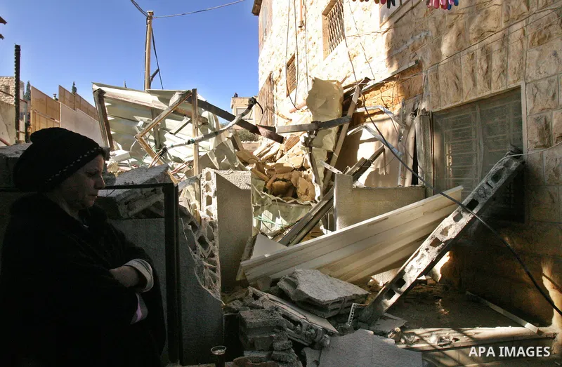 A Palestinians inspect the rubble of their house follow an Israeli bulldozer demolished it that was built without a construction permit, in the Arab Jerusalem city on Dec. 12, 2011. Photo by Mahfouz Abu Turk