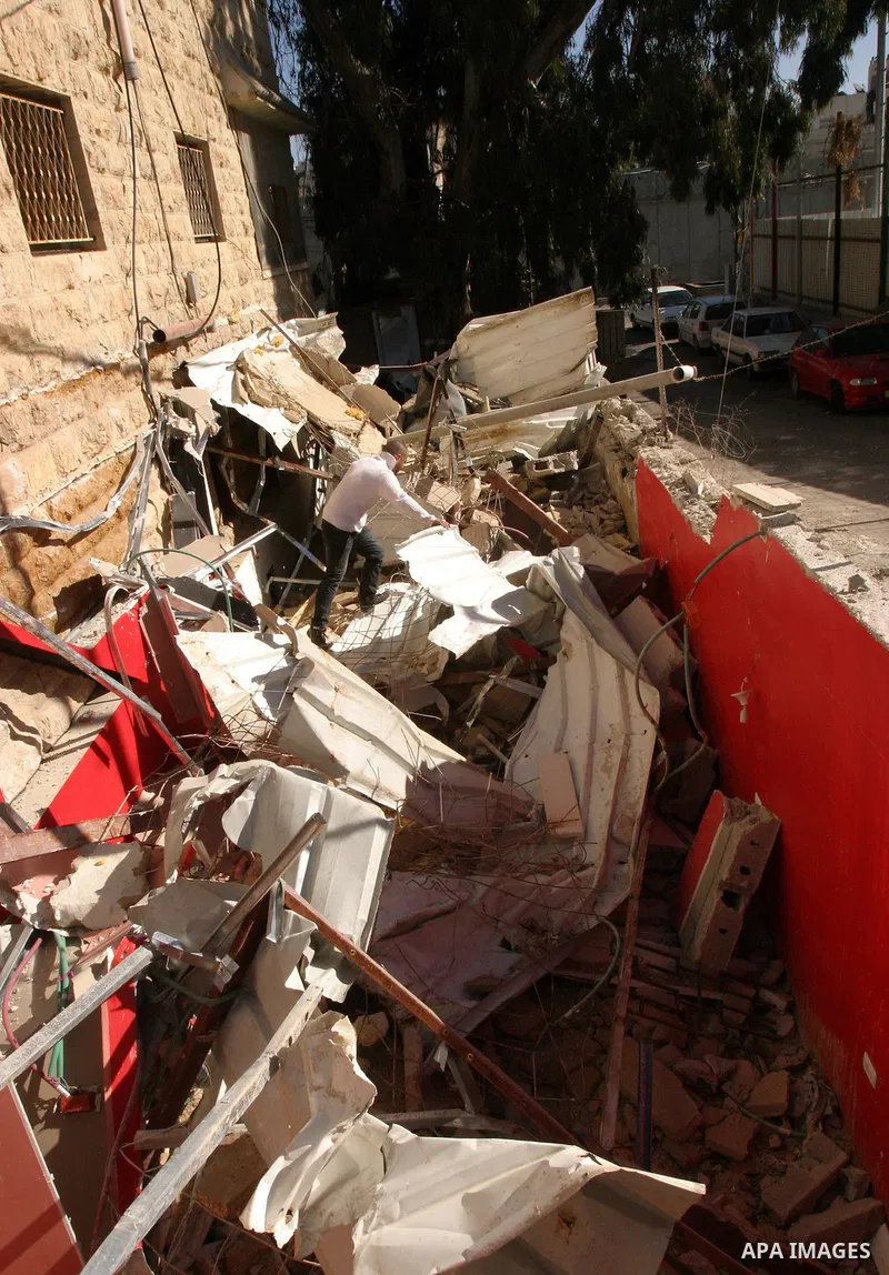 A Palestinians inspect the rubble of their house follow an Israeli bulldozer demolished it that was built without a construction permit, in the Arab Jerusalem city on Dec. 12, 2011. Photo by Mahfouz Abu Turk