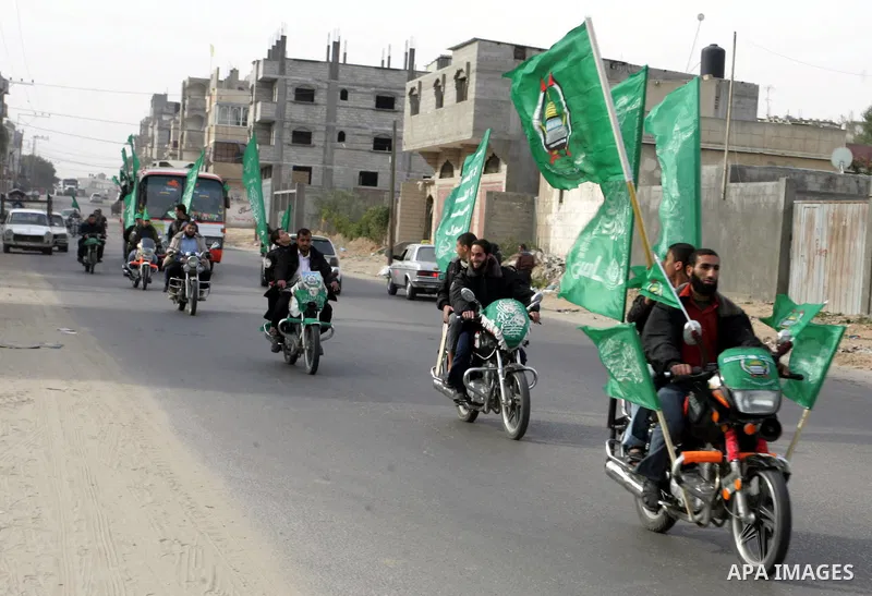 Palestinian Hamas supporters gather in the streets during the celebrations marking the Islamist movement's 24th founding anniversary, in the Rafah refugee camp in the southern Gaza Strip on December 14, 2011. Photo by Ab...