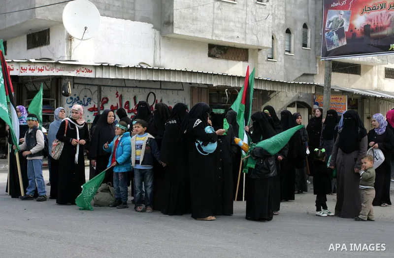 Palestinian Hamas supporters gather in the streets during the celebrations marking the Islamist movement's 24th founding anniversary, in the Rafah refugee camp in the southern Gaza Strip on December 14, 2011. Photo by Ab...