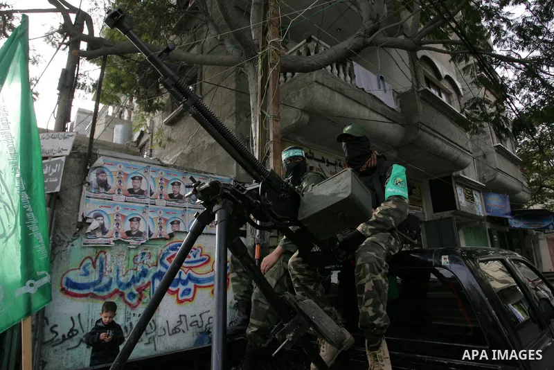 Palestinian Hamas militants patrol in the streets during the celebrations marking the Islamist movement's 24th founding anniversary, in the Rafah refugee camp in the southern Gaza Strip on December 14, 2011. Photo by Abe...