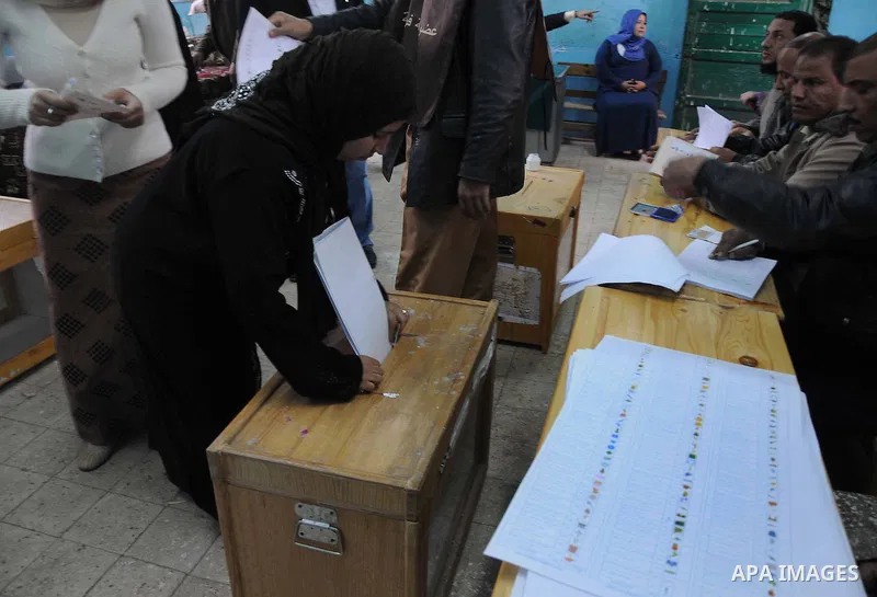 An Egyptian woman votes at a polling station in Giza, southwest of Cairo, on December 14, 2011, during the second stage of Egypt's parliamentary elections. Some 18.8 million Egyptians are eligible to cast their ballots i...
