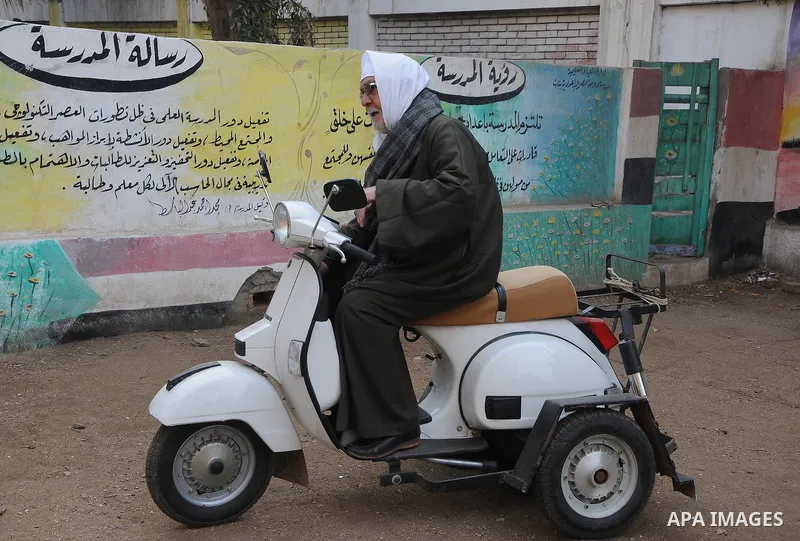 Egyptians wait to vote outside a polling station in Giza, southwest of Cairo, on December 14, 2011, during the second stage of Egypt's parliamentary elections. Some 18.8 million Egyptians are eligible to cast their ballo...