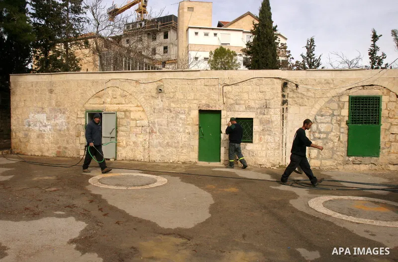 Israeli firefighters walk out of a vandalised mosque in Jerusalem December 14, 2011. The unused mosque in Jerusalem was set ablaze and graffiti sprayed on its walls on Wednesday in a manner similar to recent attacks asso...