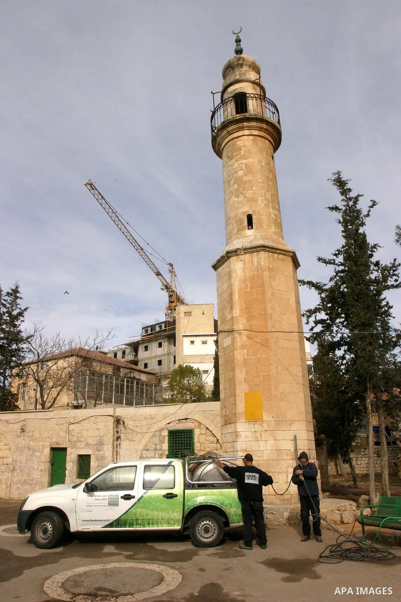 Israeli firefighters walk out of a vandalised mosque in Jerusalem December 14, 2011. The unused mosque in Jerusalem was set ablaze and graffiti sprayed on its walls on Wednesday in a manner similar to recent attacks asso...
