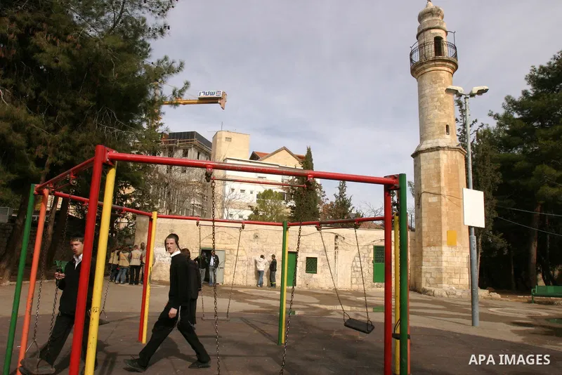 Ultra orthodox Jewish walk out of a vandalised mosque in Jerusalem December 14, 2011. The unused mosque in Jerusalem was set ablaze and graffiti sprayed on its walls on Wednesday in a manner similar to recent attacks ass...