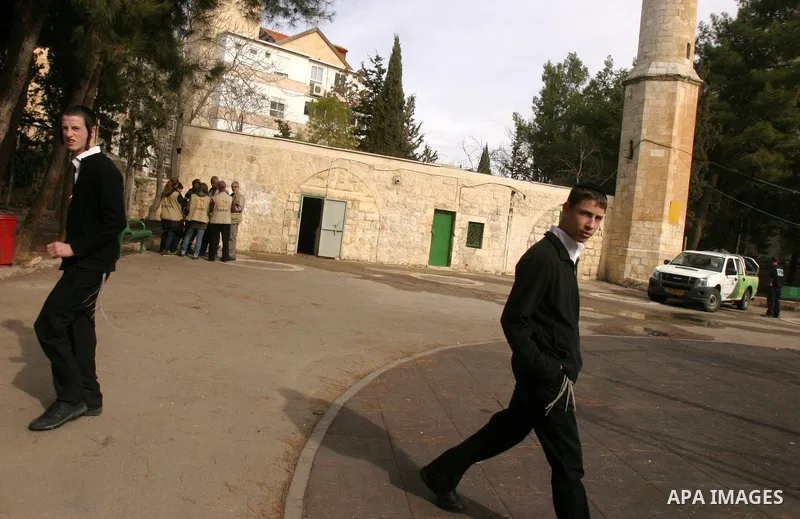 Ultra orthodox Jewish walk out of a vandalised mosque in Jerusalem December 14, 2011. The unused mosque in Jerusalem was set ablaze and graffiti sprayed on its walls on Wednesday in a manner similar to recent attacks ass...