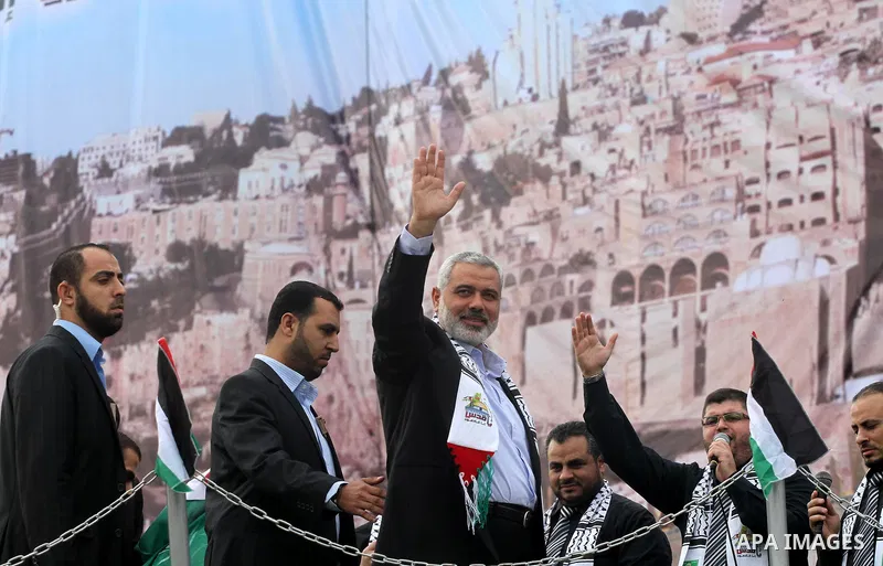 Palestinian prime minister in Gaza Strip, Ismail Haniya waves at the Islamist Hamas movement's supporters as they gather in Gaza City to celebrate the 24th anniversary of its foundation on December 14, 2011. Photo by Moh...