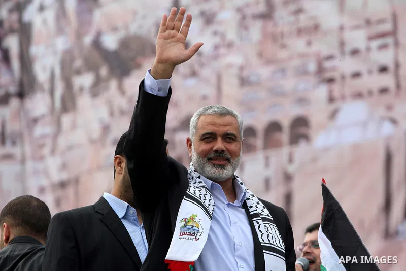 Palestinian prime minister in Gaza Strip, Ismail Haniya waves at the Islamist Hamas movement's supporters as they gather in Gaza City to celebrate the 24th anniversary of its foundation on December 14, 2011. Photo by Moh...