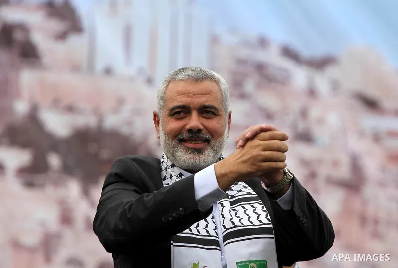 Palestinian prime minister in Gaza Strip, Ismail Haniya waves at the Islamist Hamas movement's supporters as they gather in Gaza City to celebrate the 24th anniversary of its foundation on December 14, 2011. Photo by Moh...