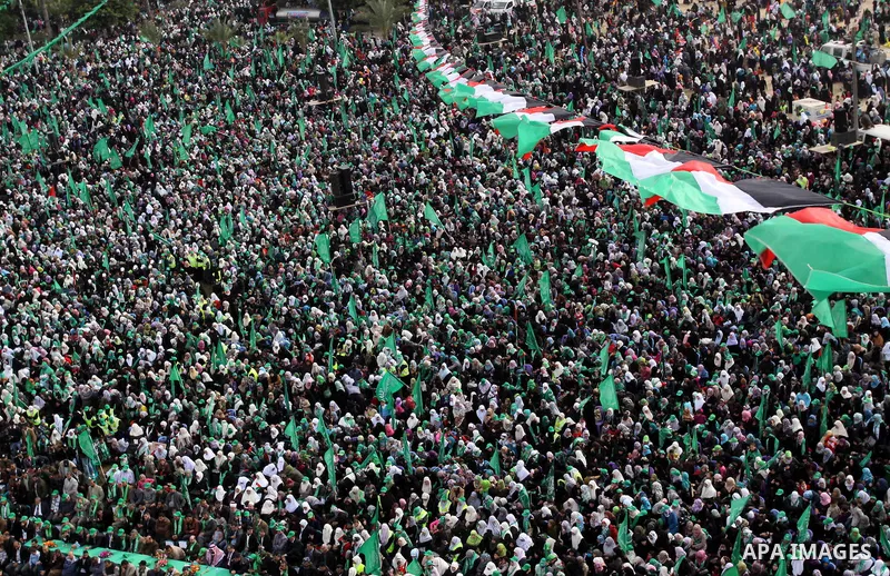 Thousands of Palestinian supporters of Hamas wave the Islamist movement's flags during celebrations for the 24th anniversary of its foundation in Gaza City on December 14, 2011. Photo by Mohammed Asad