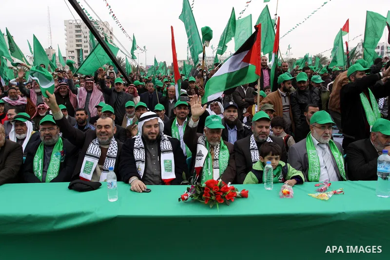 Thousands of Palestinian supporters of Hamas wave the Islamist movement's flags during celebrations for the 24th anniversary of its foundation in Gaza City on December 14, 2011. Photo by Mohammed Asad