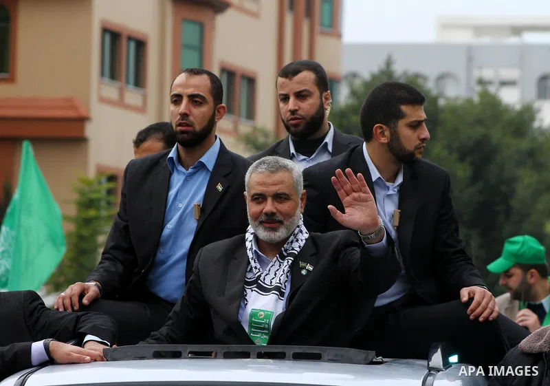 Palestinian prime minister in Gaza Strip, Ismail Haniya waves at the Islamist Hamas movement's supporters as they gather in Gaza City to celebrate the 24th anniversary of its foundation on December 14, 2011. Photo by Ash...