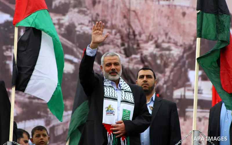 Palestinian prime minister in Gaza Strip, Ismail Haniya waves at the Islamist Hamas movement's supporters as they gather in Gaza City to celebrate the 24th anniversary of its foundation on December 14, 2011. Photo by Ash...