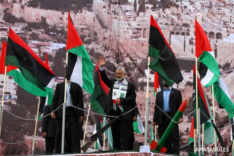 Palestinian prime minister in Gaza Strip, Ismail Haniya waves at the Islamist Hamas movement's supporters as they gather in Gaza City to celebrate the 24th anniversary of its foundation on December 14, 2011. Photo by Ash...