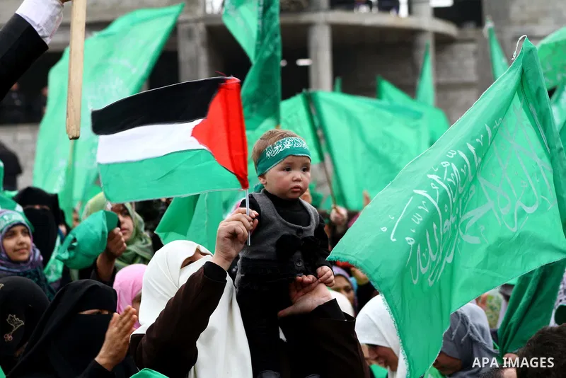 Thousands of Palestinian supporters of Hamas wave the Islamist movement's flags during celebrations for the 24th anniversary of its foundation in Gaza City on December 14, 2011. Photo by Ashraf Amra