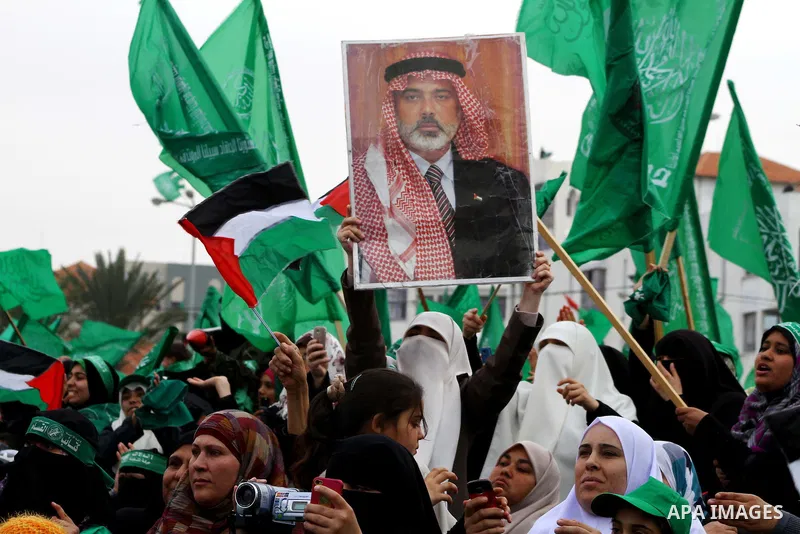 Thousands of Palestinian supporters of Hamas wave the Islamist movement's flags during celebrations for the 24th anniversary of its foundation in Gaza City on December 14, 2011. Photo by Ashraf Amra