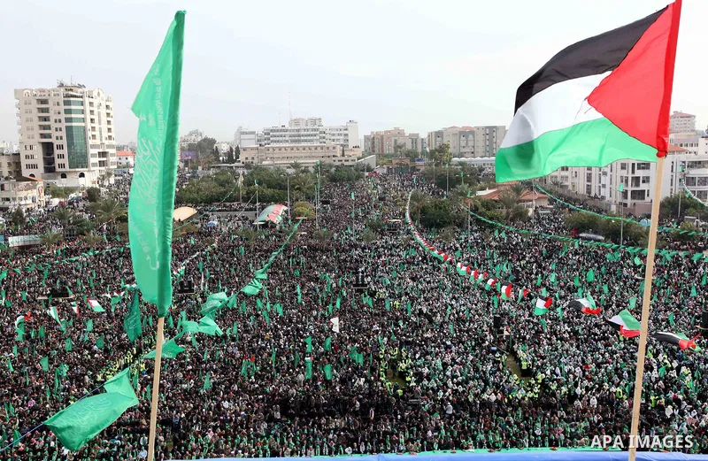 Thousands of Palestinian supporters of Hamas wave the Islamist movement's flags during celebrations for the 24th anniversary of its foundation in Gaza City on December 14, 2011. Photo by Ashraf Amra