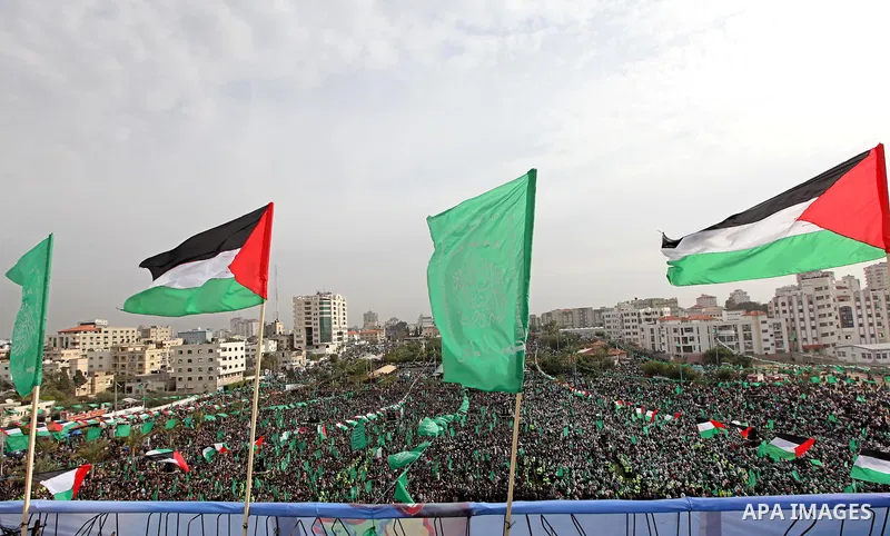 Thousands of Palestinian supporters of Hamas wave the Islamist movement's flags during celebrations for the 24th anniversary of its foundation in Gaza City on December 14, 2011. Photo by Ashraf Amra