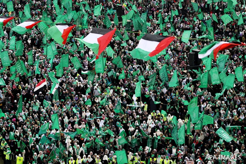 Thousands of Palestinian supporters of Hamas wave the Islamist movement's flags during celebrations for the 24th anniversary of its foundation in Gaza City on December 14, 2011. Photo by Ashraf Amra