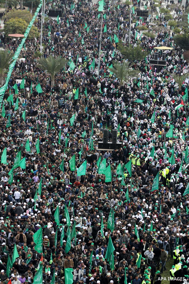 Thousands of Palestinian supporters of Hamas wave the Islamist movement's flags during celebrations for the 24th anniversary of its foundation in Gaza City on December 14, 2011. Photo by Ashraf Amra
