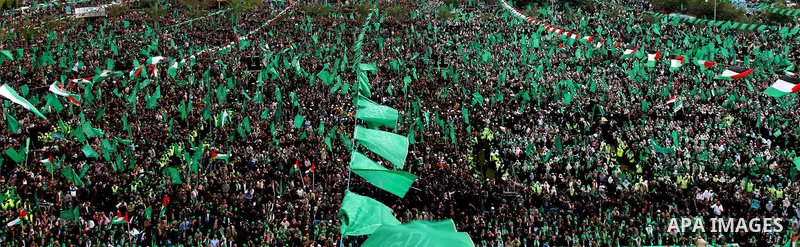 Thousands of Palestinian supporters of Hamas wave the Islamist movement's flags during celebrations for the 24th anniversary of its foundation in Gaza City on December 14, 2011. Photo by Ashraf Amra