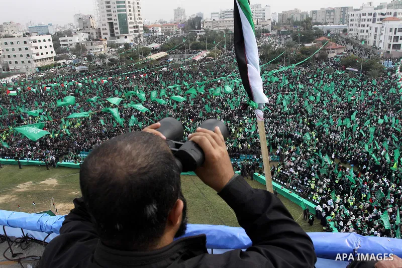 Thousands of Palestinian supporters of Hamas wave the Islamist movement's flags during celebrations for the 24th anniversary of its foundation in Gaza City on December 14, 2011. Photo by Ashraf Amra