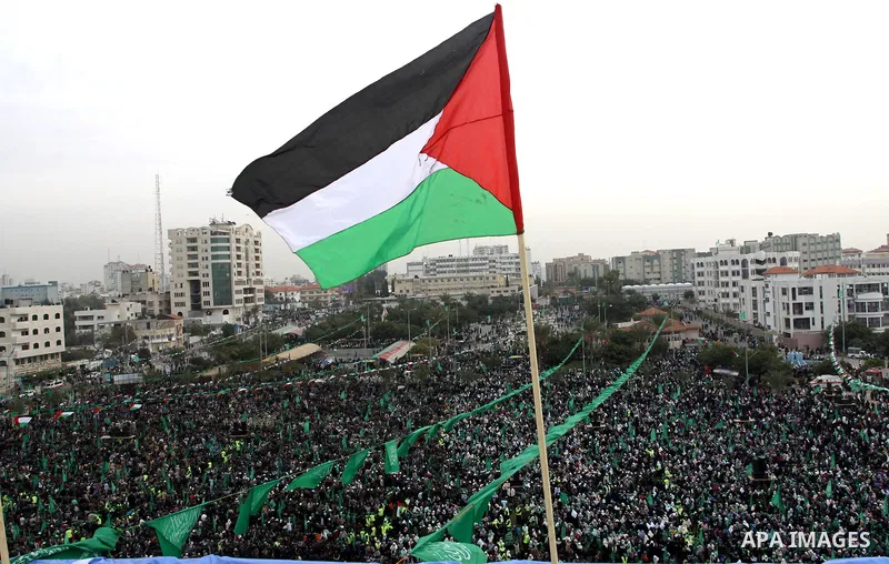 Thousands of Palestinian supporters of Hamas wave the Islamist movement's flags during celebrations for the 24th anniversary of its foundation in Gaza City on December 14, 2011. Photo by Ashraf Amra