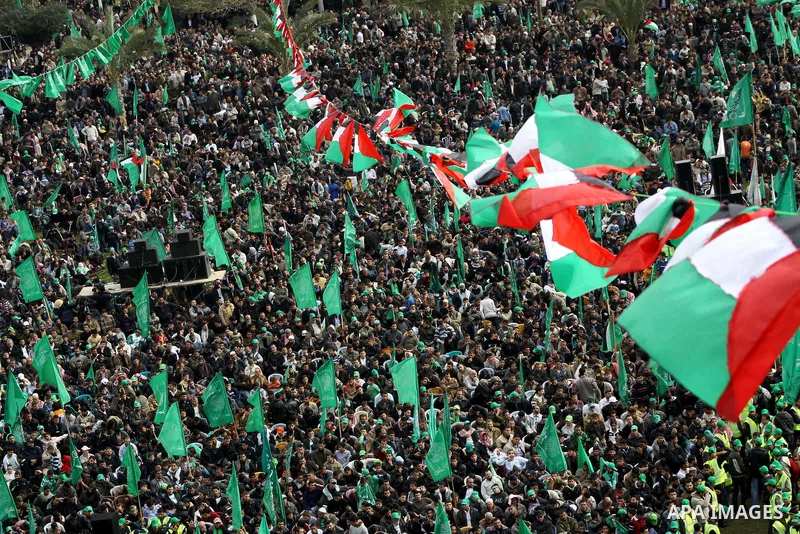 Thousands of Palestinian supporters of Hamas wave the Islamist movement's flags during celebrations for the 24th anniversary of its foundation in Gaza City on December 14, 2011. Photo by Ashraf Amra